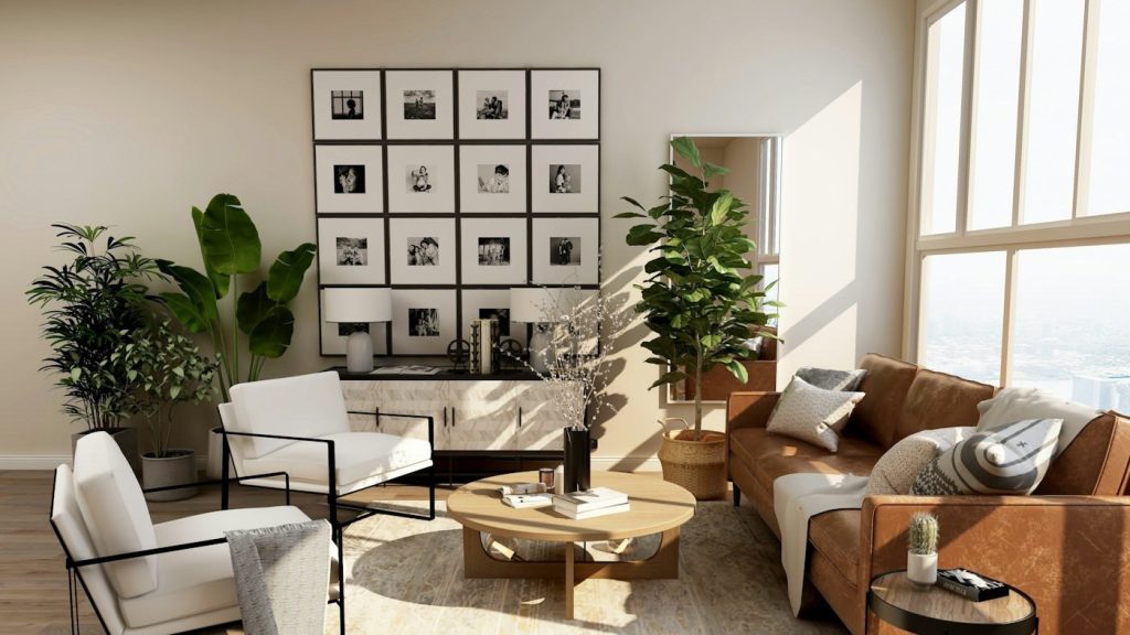 Sunlit modern living room arranged with sofa, chairs, coffee table, plants, and coordinated decor